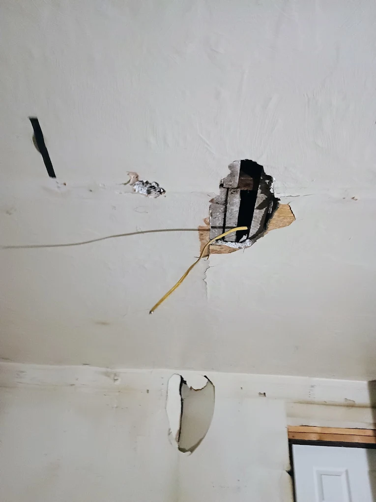 Drywall and plaster repair — wall damage being restored